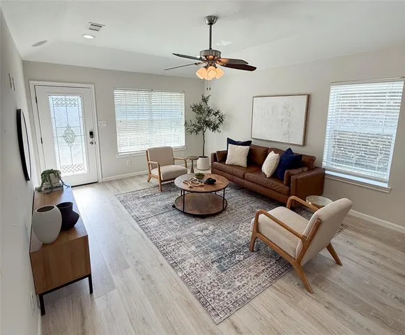 a living room with furniture a window and a table