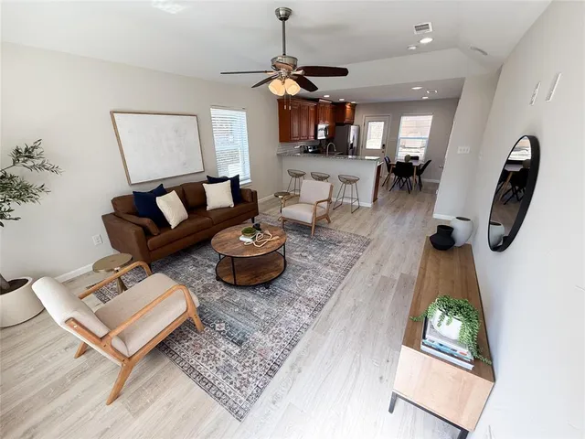 a living room with furniture and a wooden floor