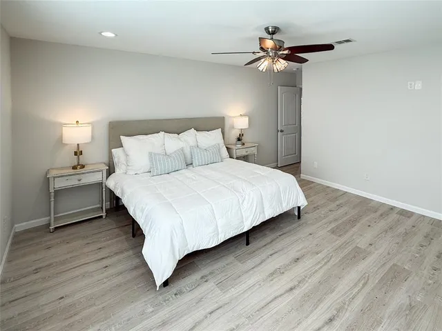 a bedroom with bed and a chandelier