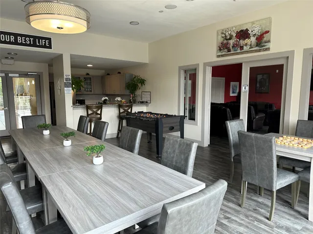 a view of a balcony with chairs and wooden floor
