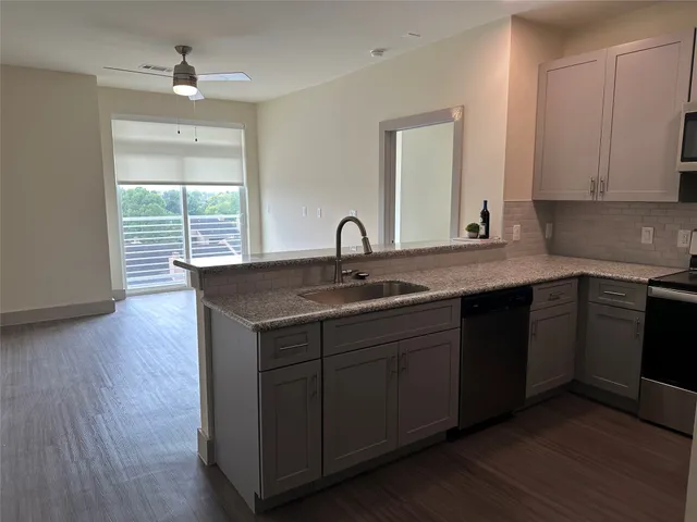 a kitchen with sink and cabinets