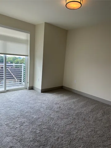 a view of a room with wooden floor and window