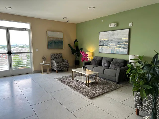 a living room with furniture and a potted plant