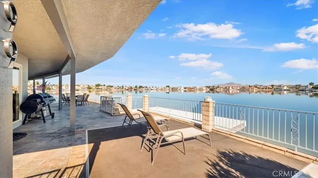 a view of a terrace with furniture and city view