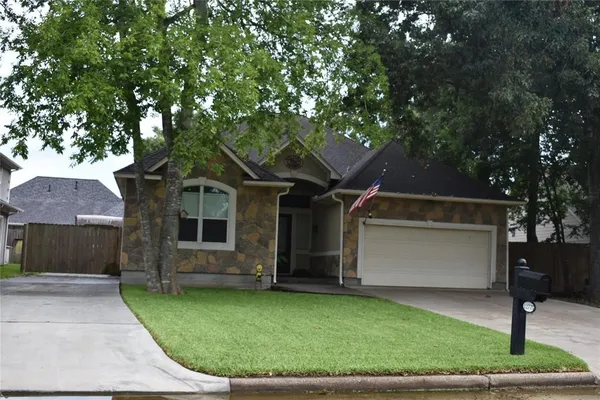 a front view of house with a garden