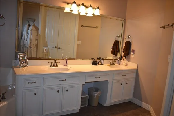 a bathroom with a double vanity sink mirror and