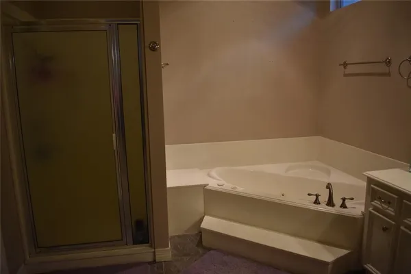 a bathroom with a bathtub and shower