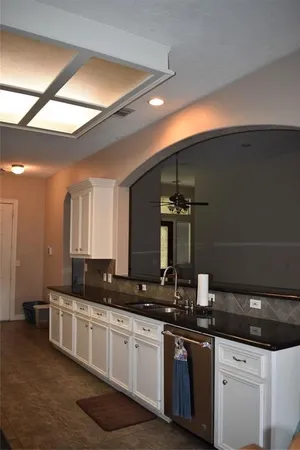 a kitchen with a sink and cabinets