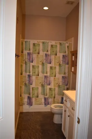 a bathroom with a toilet a sink and a shower
