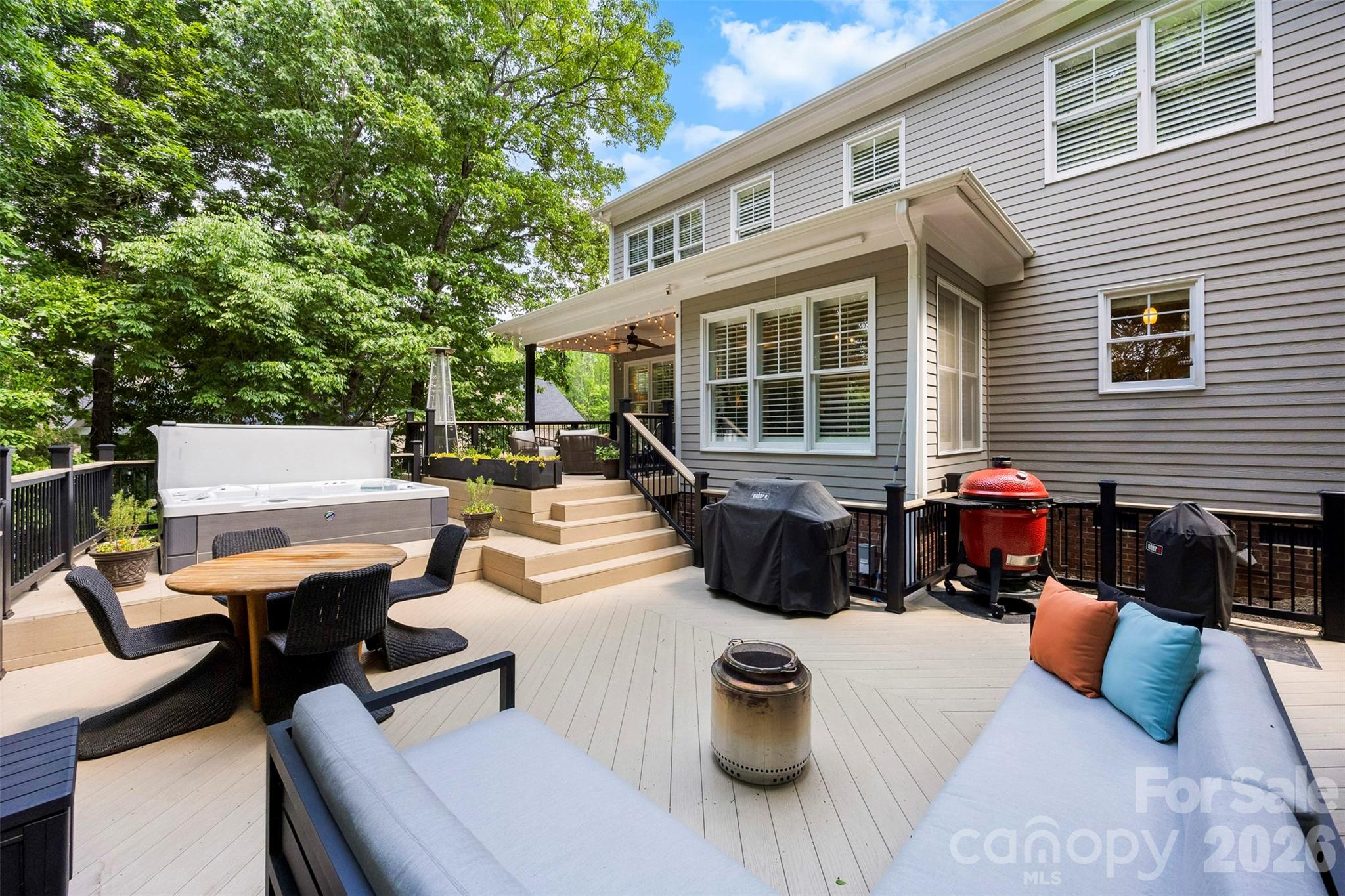 606 Andover Lane Tega Cay, SC 29708 - Photo 32 of 48 a view of a patio with couches table and chairs and potted plants