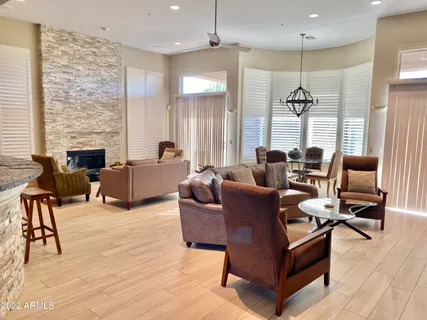 a living room with furniture wooden floor and a fireplace