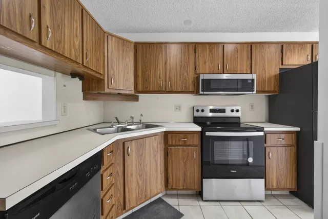 an empty room with closet and windows