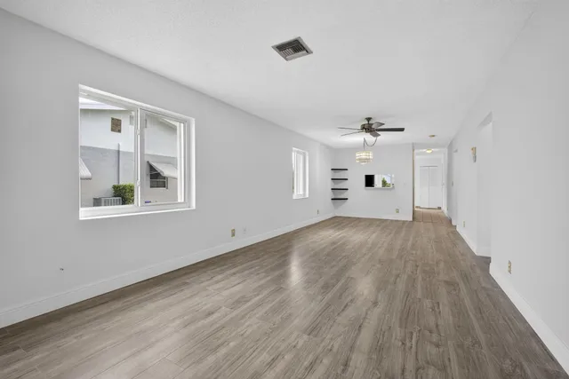 a view of an empty room and wooden floor