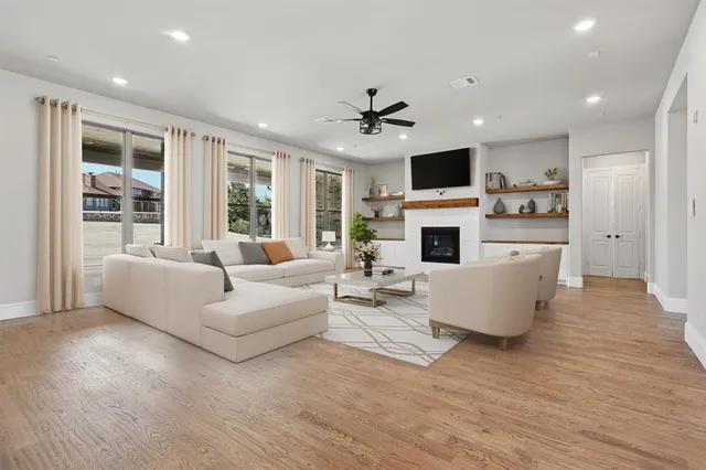 a large kitchen with kitchen island a sink a center island a stove and a chandelier