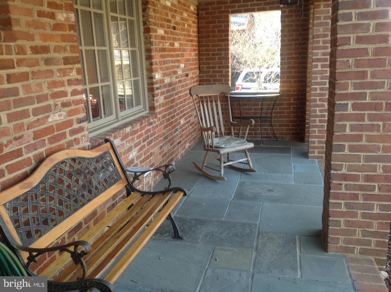 7125 Catlett Street Springfield, VA 22151 - Photo 2 of 26 a bench sitting in front of a door