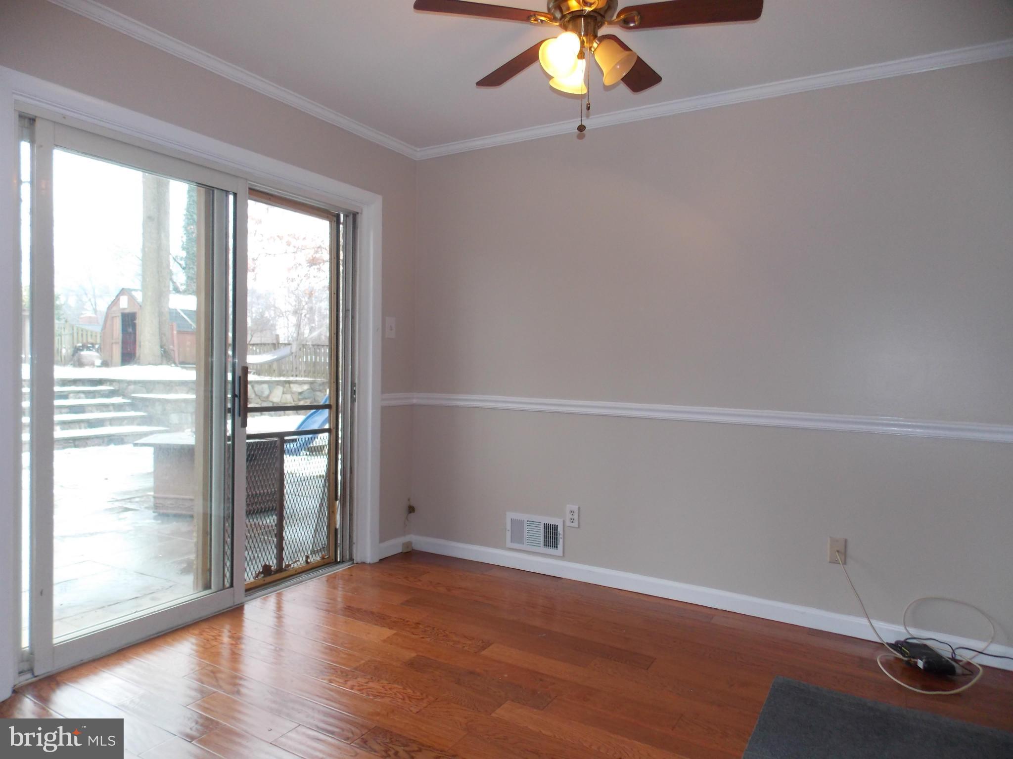 7125 Catlett Street Springfield, VA 22151 - Photo 11 of 26 an empty room with wooden floor and windows