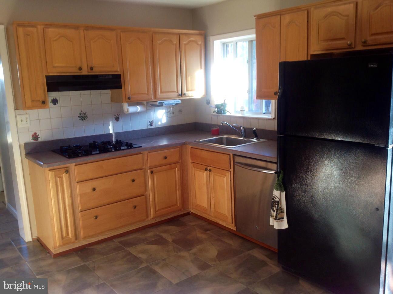 7125 Catlett Street Springfield, VA 22151 - Photo 13 of 26 a kitchen with a sink and cabinets