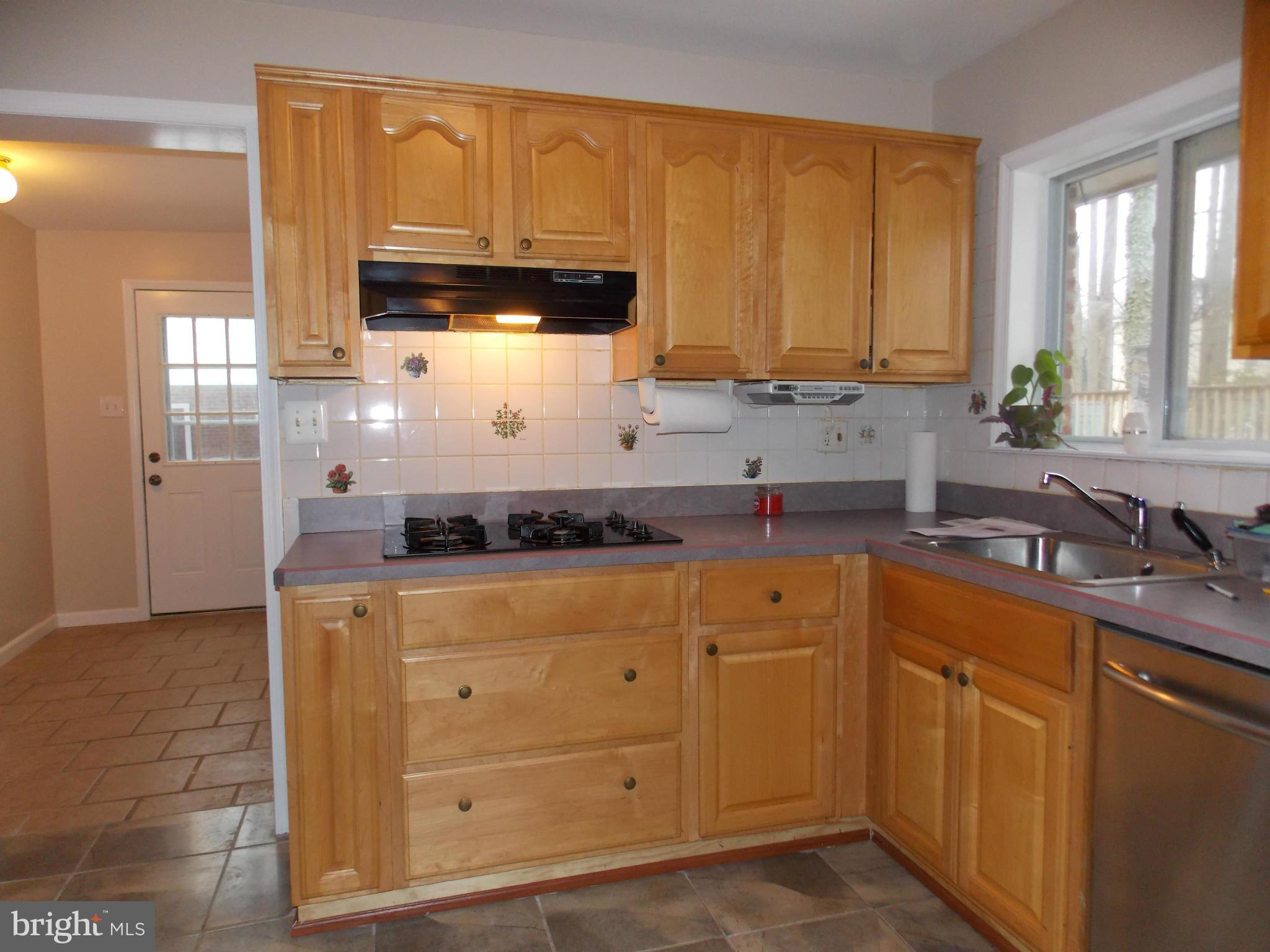 7125 Catlett Street Springfield, VA 22151 - Photo 14 of 26 a kitchen with stainless steel appliances granite countertop a sink stove and cabinets