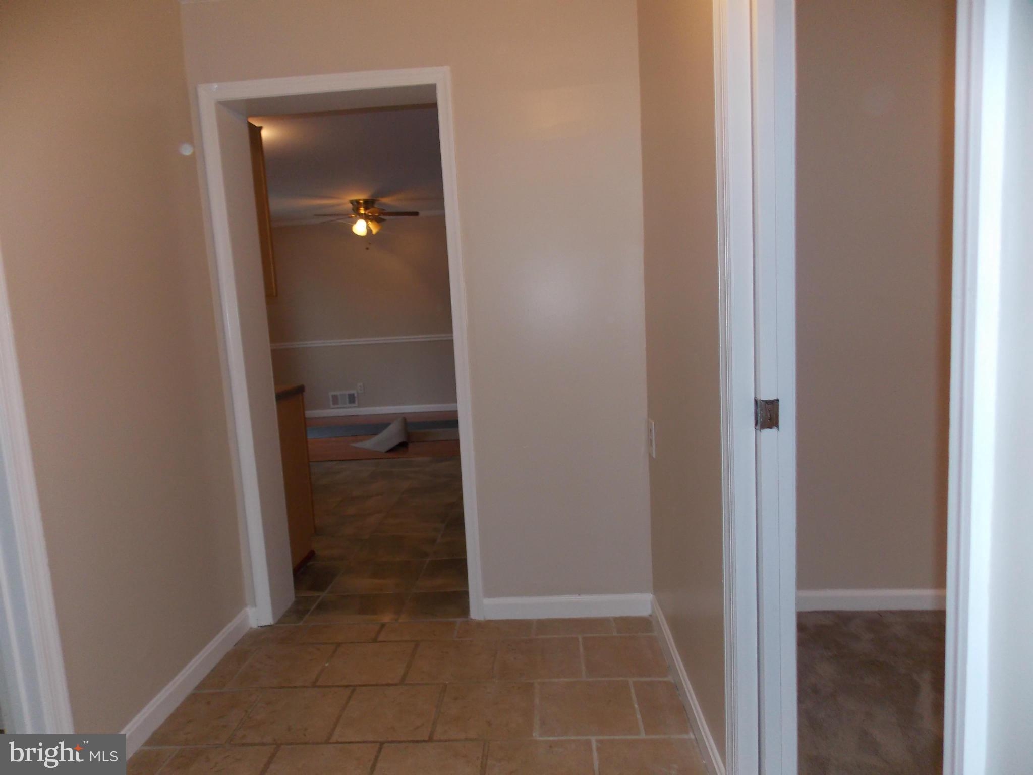 7125 Catlett Street Springfield, VA 22151 - Photo 17 of 26 a view of a bathroom from a corridor
