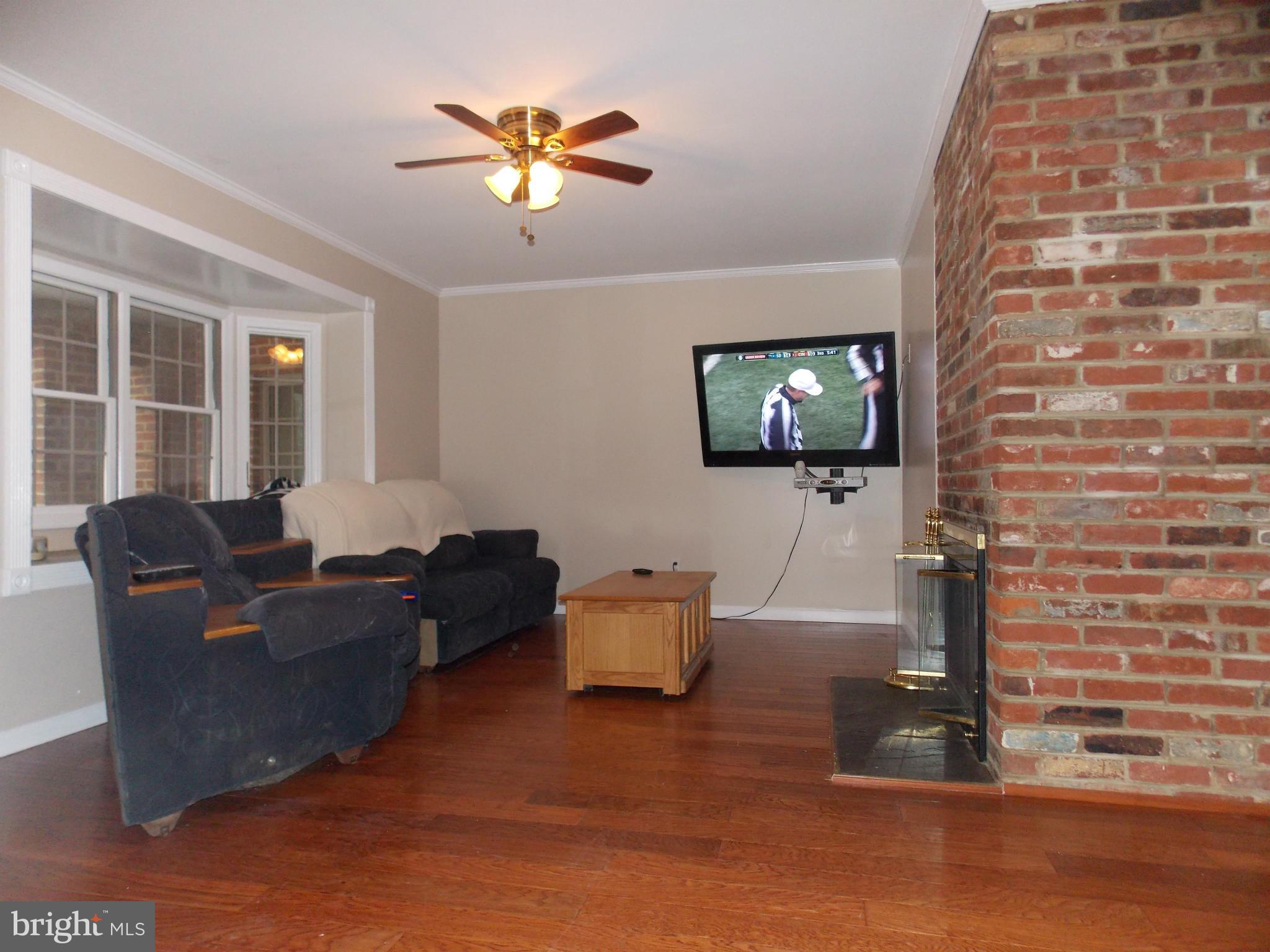 7125 Catlett Street Springfield, VA 22151 - Photo 6 of 26 a living room with furniture and a flat screen tv