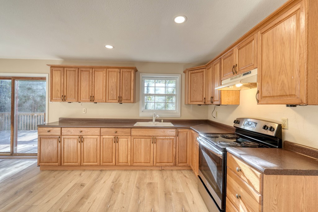 110 Johnson Road Hayesville, NC 28904 - Photo 12 of 41 a kitchen with stainless steel appliances granite countertop a stove a sink and a refrigerator