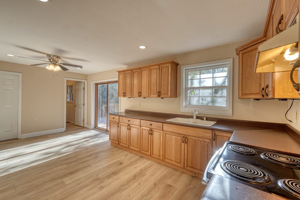 110 Johnson Road Hayesville, NC 28904 - Photo 13 of 41 a kitchen with stainless steel appliances granite countertop a sink stove and wooden floor