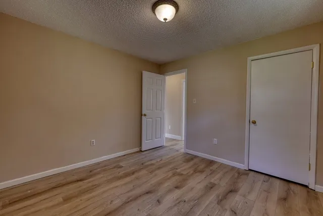 a view of an empty room and wooden floor