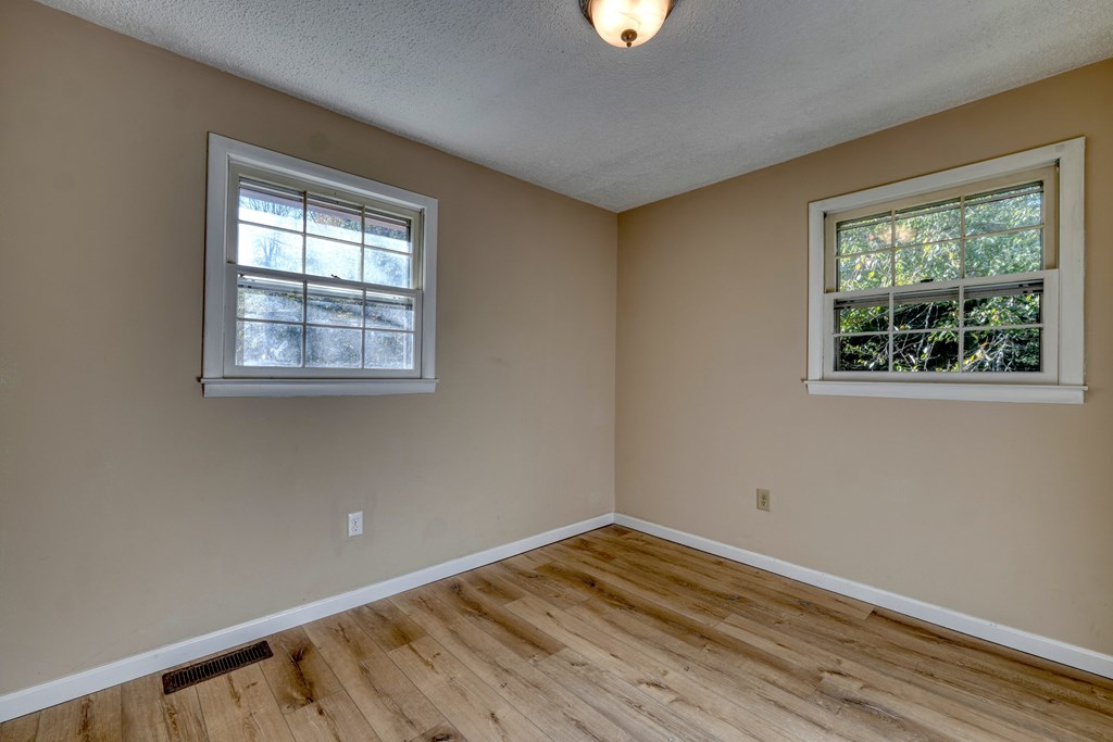 110 Johnson Road Hayesville, NC 28904 - Photo 22 of 41 a view of empty room with wooden floor and fan