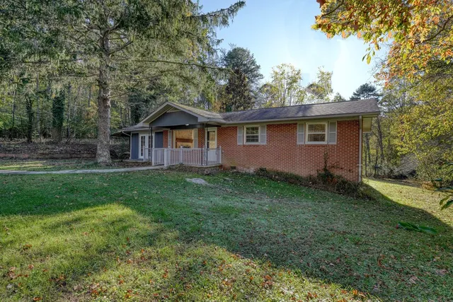 a view of an house with backyard space and garden