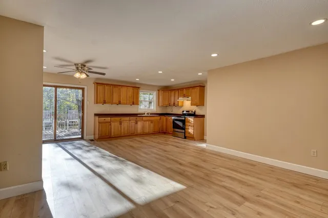 a big room with wooden floor and windows