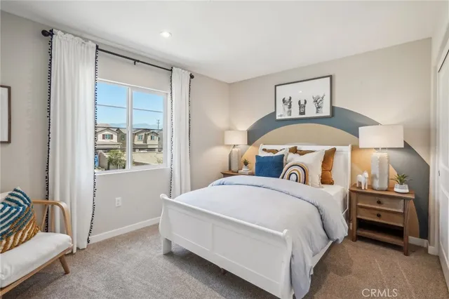 a bedroom with a bed and a painting on the wall