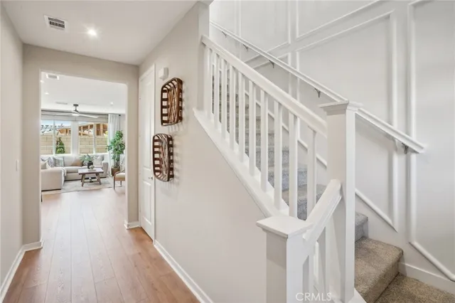 a view of entryway and hall with wooden floor