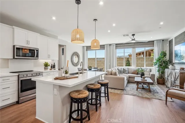 a large kitchen with a table and chairs