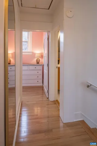 a view of hallway with wooden floor