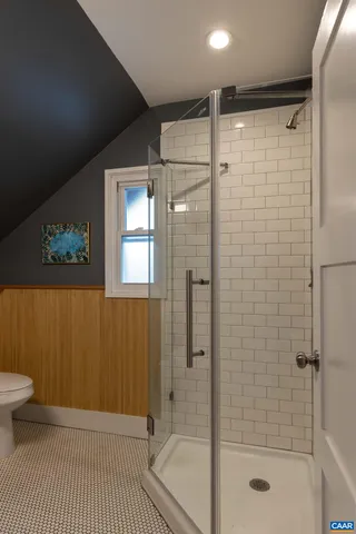 a bathroom with a shower and a toilet