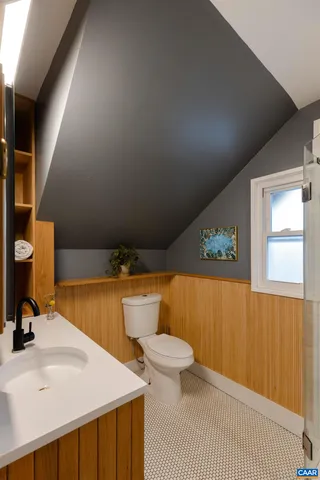 a bathroom with a sink a toilet and mirror
