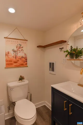 a bathroom with a toilet a sink and mirror