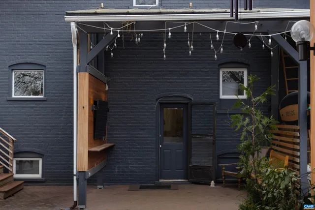 a front view of a house with plants