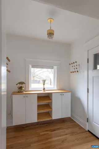 a kitchen with granite countertop a sink cabinets and wooden floor