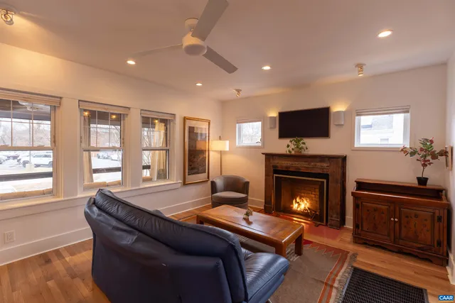 a living room with furniture a flat screen tv and a fireplace