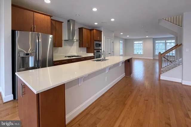 a view of kitchen with wooden cabinet
