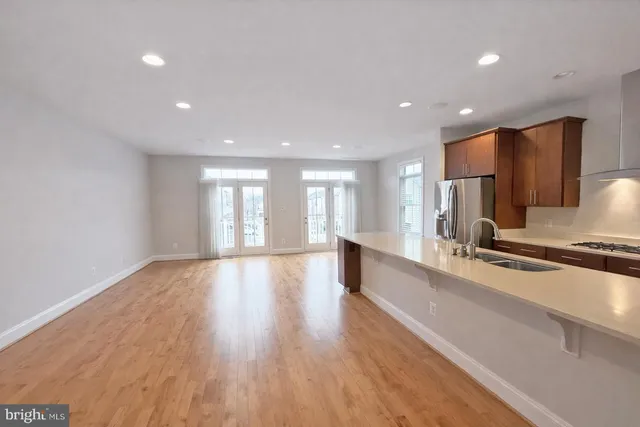 a view of kitchen with refrigerator and windows