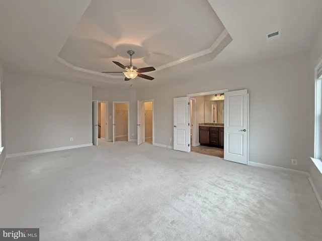 a bathroom with a granite countertop sink a light fixture and a mirror