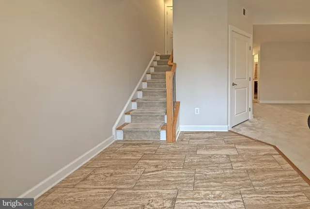 a view of an empty room with stairs