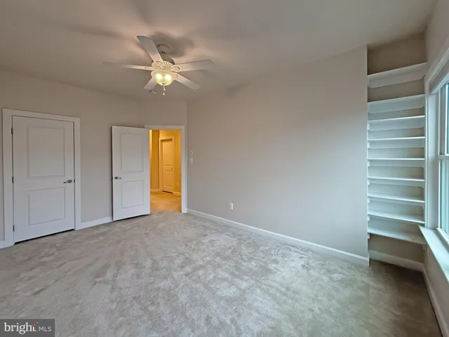 a bathroom with a granite countertop sink a toilet a mirror a bathtub and shower