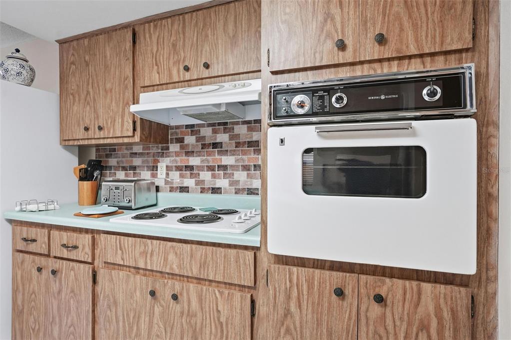 7329 Cay Drive Port Richey, FL 34668 - Photo 12 of 38 a kitchen with a stove and a microwave