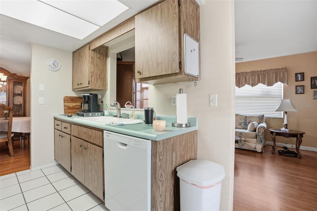 7329 Cay Drive Port Richey, FL 34668 - Photo 15 of 38 a kitchen with a sink cabinets and wooden floor