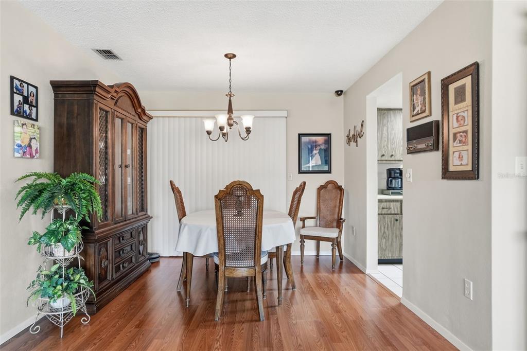 7329 Cay Drive Port Richey, FL 34668 - Photo 16 of 38 a view of a dining room with furniture and wooden floor