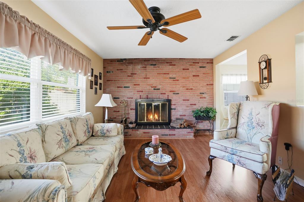 7329 Cay Drive Port Richey, FL 34668 - Photo 17 of 38 a living room with furniture and a fireplace