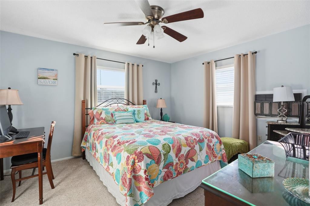 7329 Cay Drive Port Richey, FL 34668 - Photo 23 of 38 a bedroom with a bed and a table in it